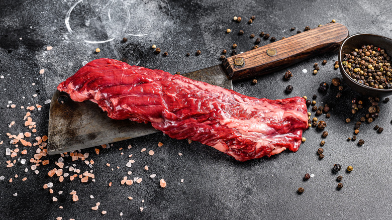 Raw skirt steak on a cleaver