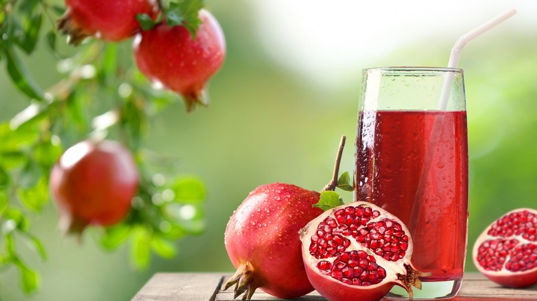 Glass of pomegranate juice with fresh pomegranates