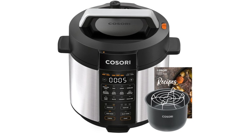 A Cosori pressure cooker with recipe book on white background
