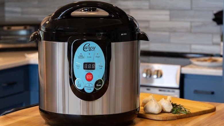 A Nesco Carey pressure cooker on kitchen table