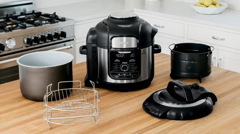 A Ninja Foodi Deluxe Pressure Cooker & Air Fryer on kitchen table