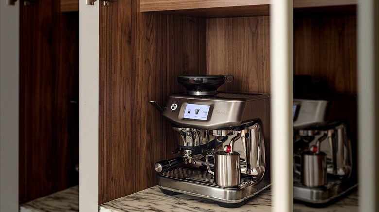 Silver Breville Barista Touch Impress model on countertop with shelves