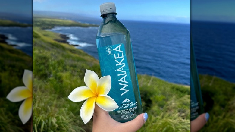 Hand holding Waiākea bottle