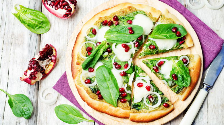 Pomegranate seeds on pizza