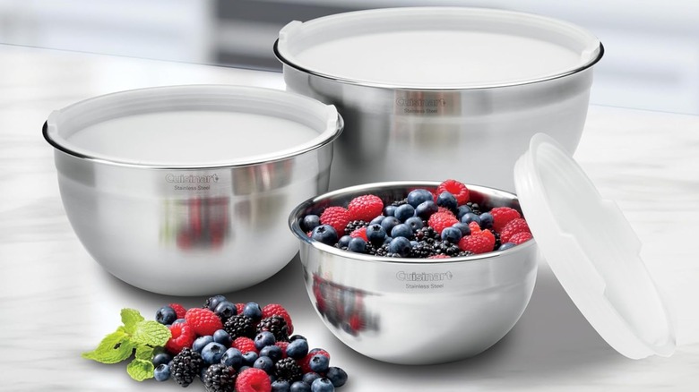 Three stainless steel Cuisinart mixing bowls with white lids