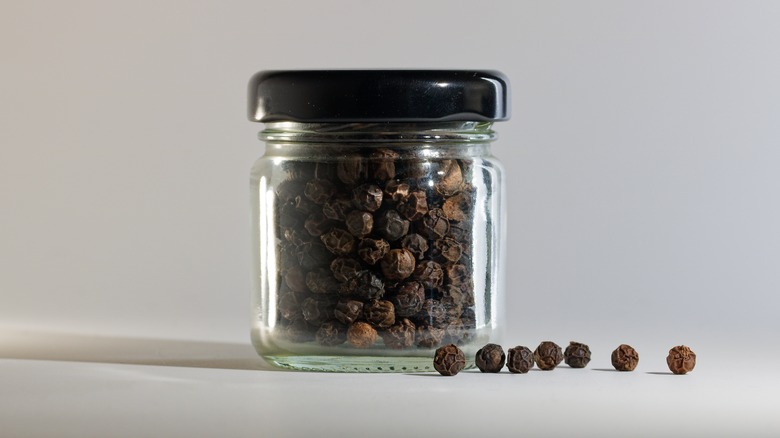 Glass jar filled with peppercorns