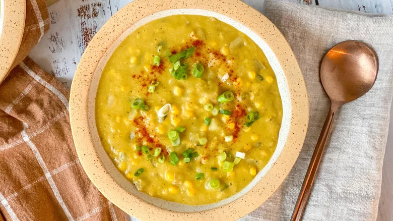 Corn chowder in bowl with spoon