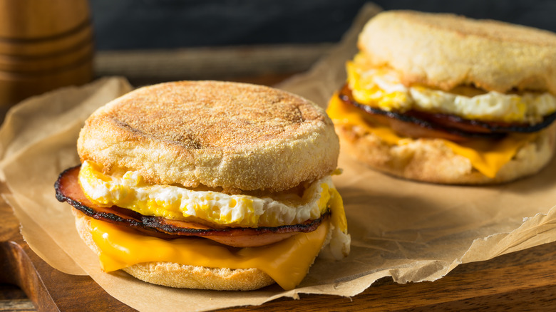 two breakfast sandwiches on paper