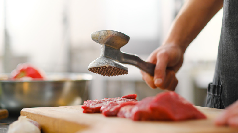 Chef using meat mallet