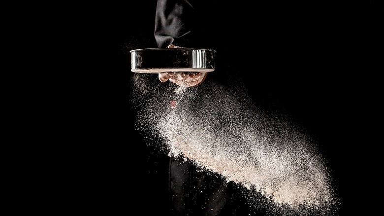 Person sifting flour