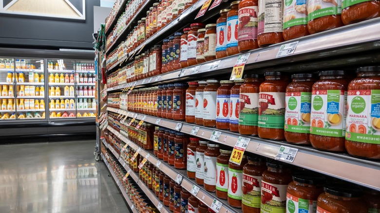 Jars of pasta sauce on grocery shelves