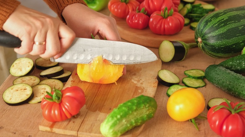 Person chopping colorful vegetables