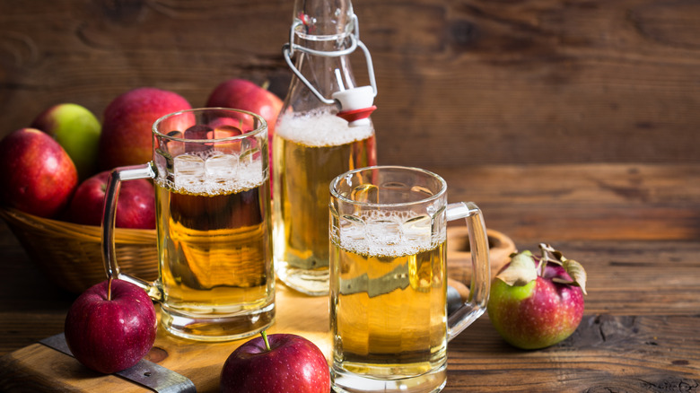 Glasses of hard cider and apples