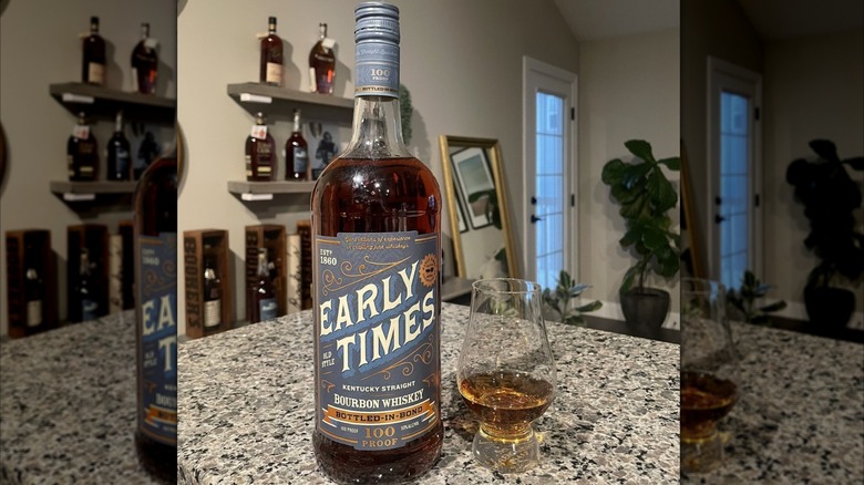 Early Times Bottled-In-Bond whiskey on a kitchen counter with whiskey bottles in the background