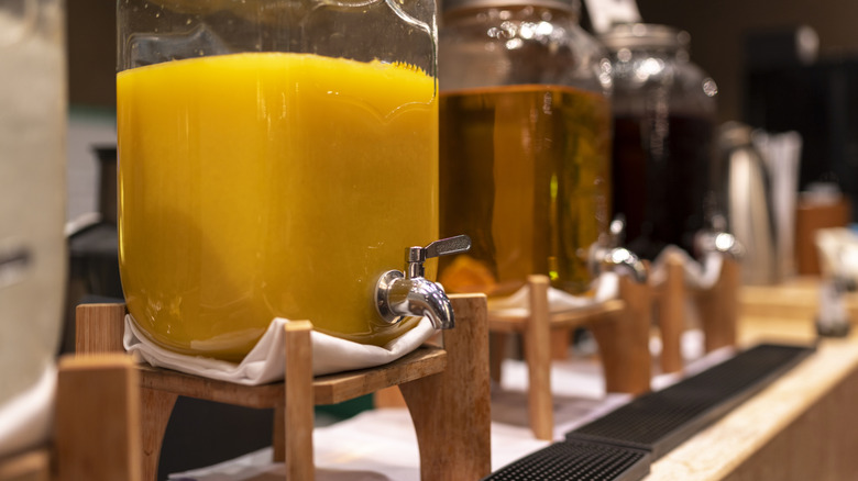 Juice options in large drinks dispensers at a buffet