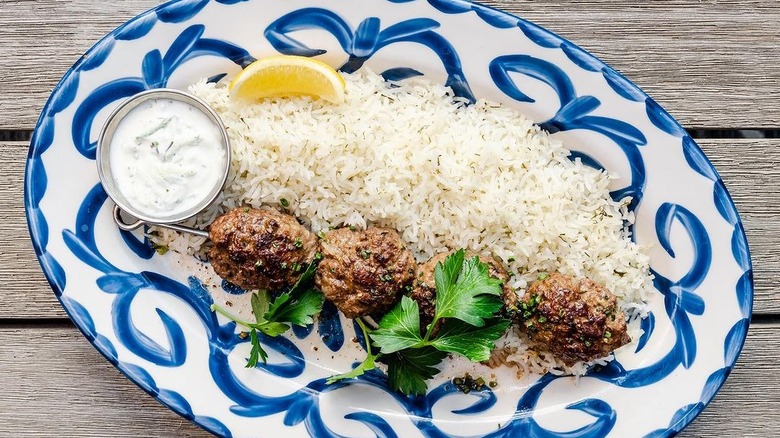 Aba's lamb and beef kefta platter on wooden table