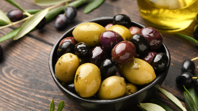 Mediterranean black and green olives in black bowl