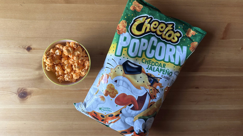 Cheddar Jalapeno Popcorn Cheetos bag with bowl on wooden table