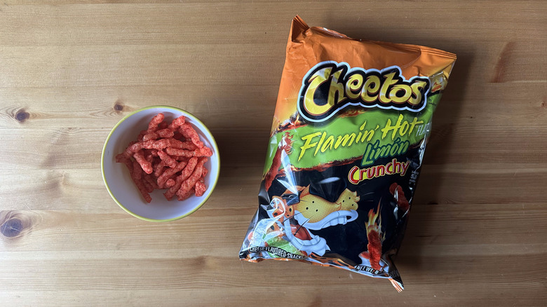 Flamin' Hot Limon Crunchy Cheetos bag with bowl on wooden table