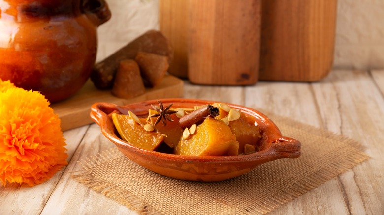 Candied pumpkin in a brown ceramic bowl