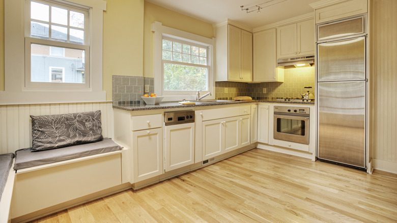 Color drenched light yellow kitchen