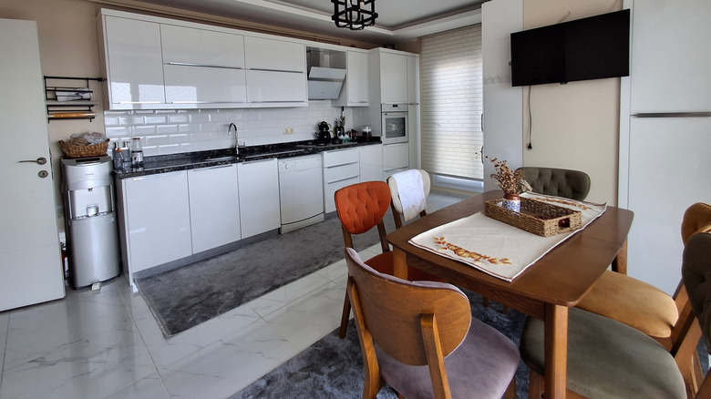 Kitchen with large marble floor tiles and dining area