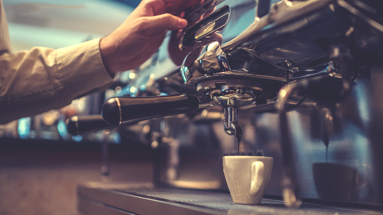 person making espresso shot