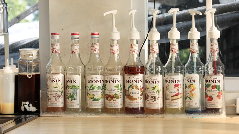 Monin coffee syrup bottles with pumps in a cafe