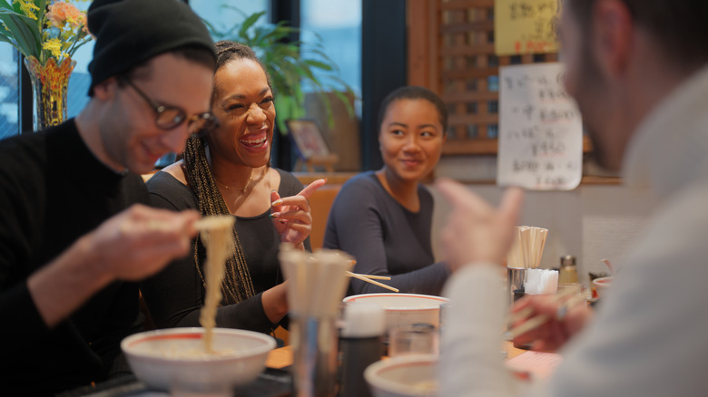 Group eating ramen in restaurant