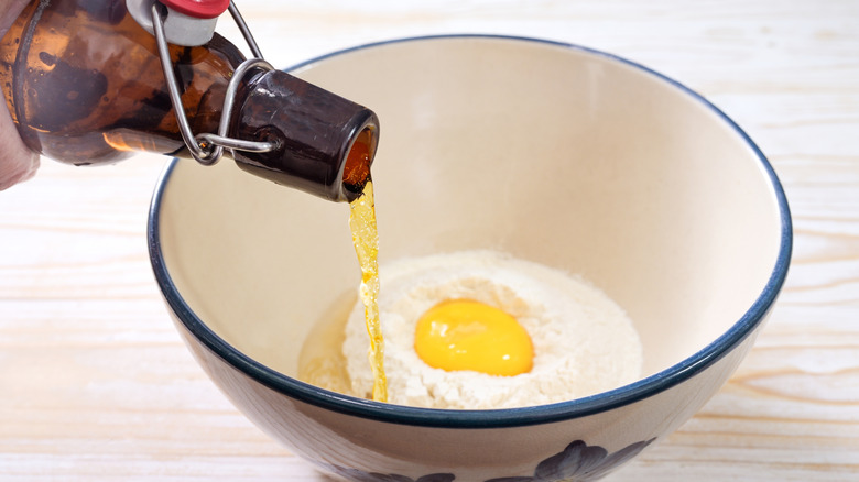 Beer being added to batter mix in bowl