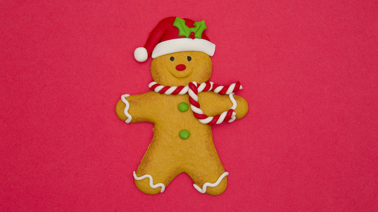 Gingerbread man with a red hat and scarf of a red background