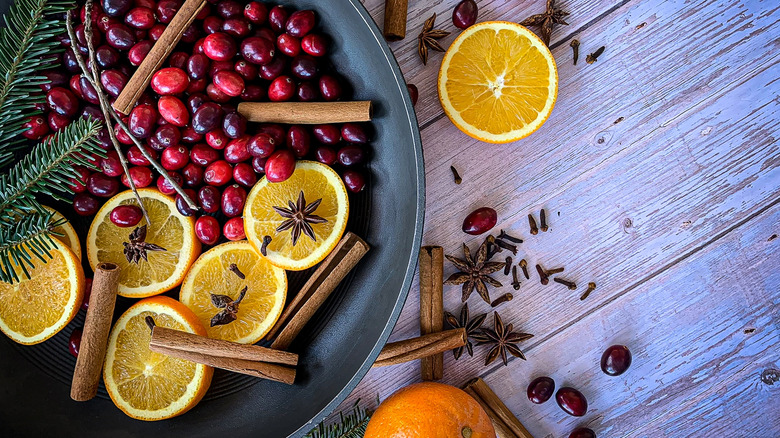 Simmer pot with cranberries, orange slices, and cinnamon sticks