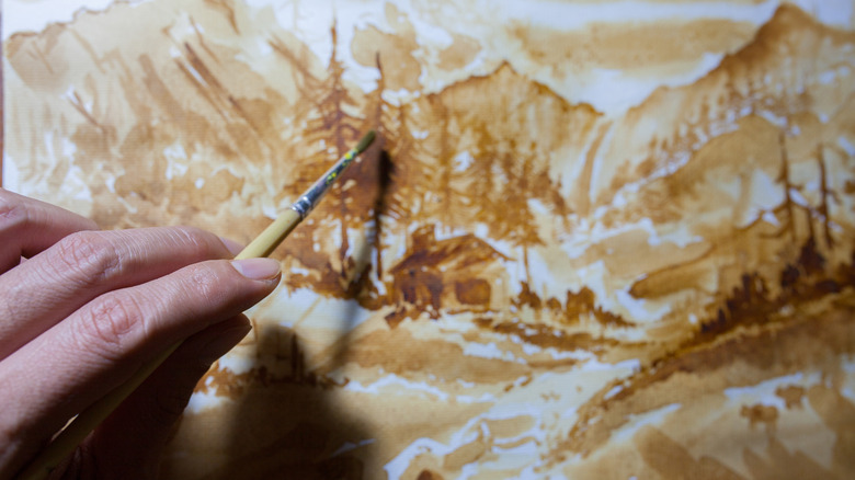 Painting landscape scene with tea