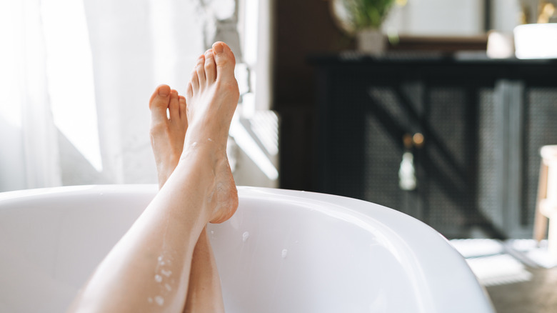 feet resting on edge of bath