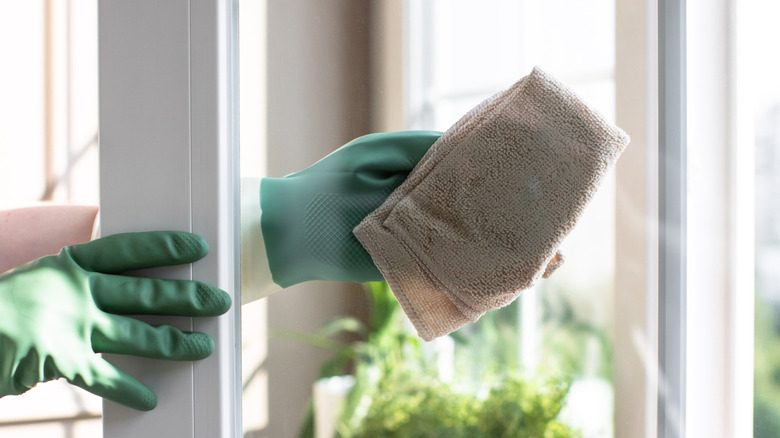 Wiping window with microfiber cloth