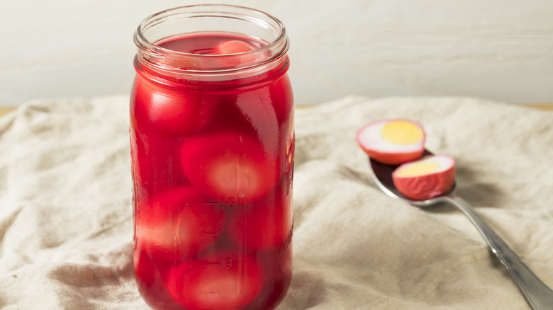 Pink pickled eggs in jar