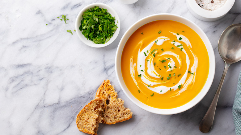 Pumpkin soup in white bowl 