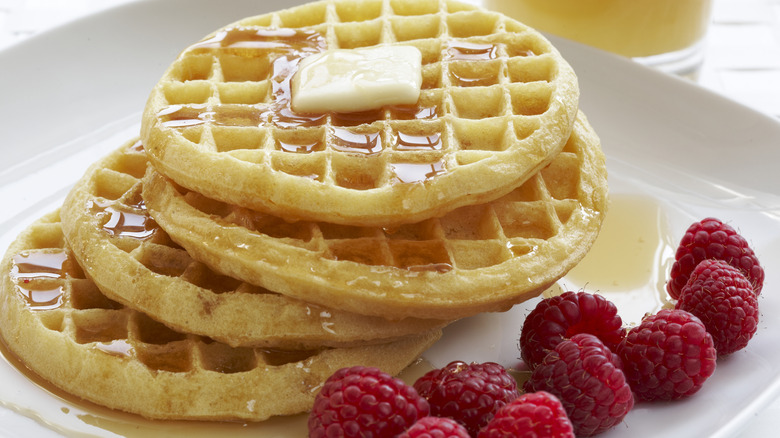 Waffles with butter, syrup and fresh raspberries