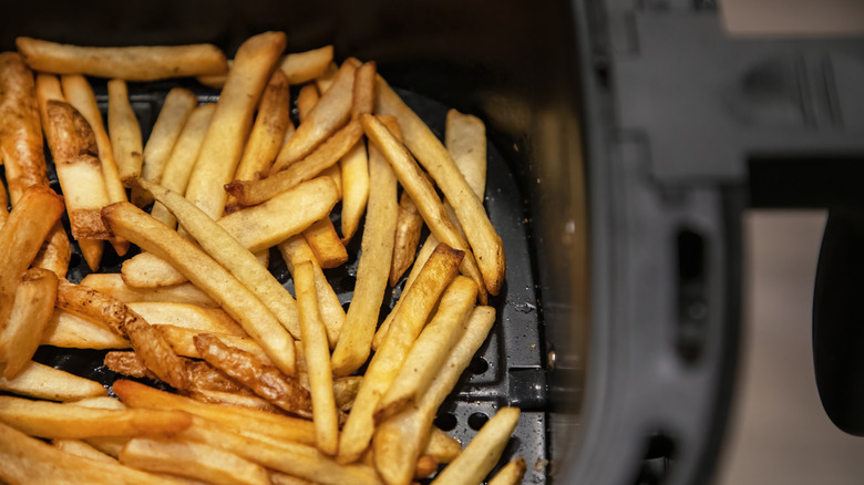 Homemade French fries in black air fryer basket
