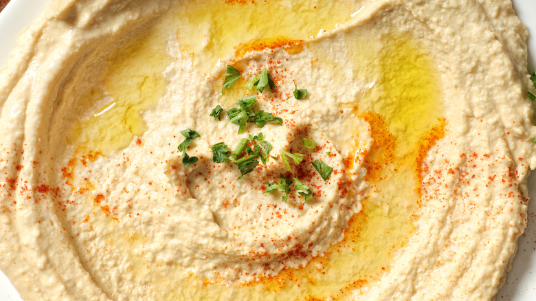 Hummus with olive oil and seasonings close up
