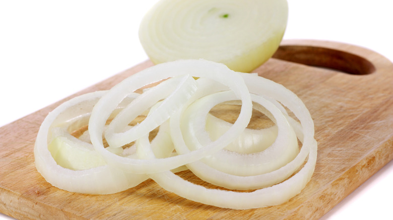 Sliced white onions on cutting board