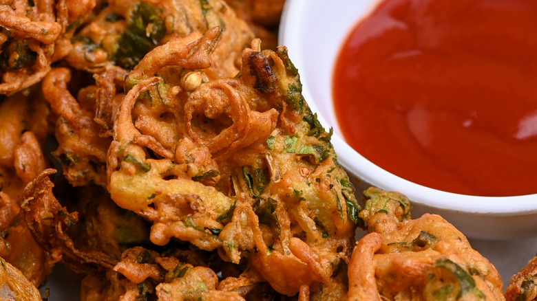 Traditional Indian pakora close view with dipping sauce