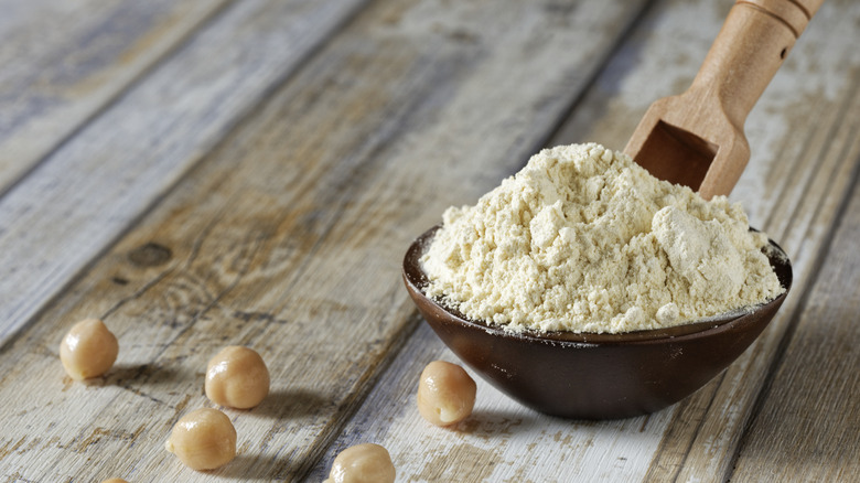 Bowl of chickpea flour with wooden spoon