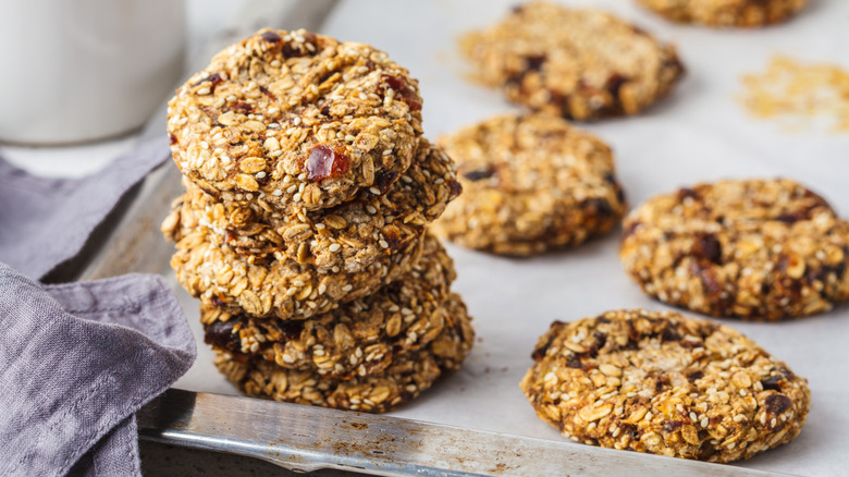 Stack of date oatmeal cookies on baking sheet