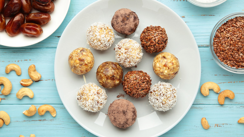 Plate of various energy balls made with dates, nuts, and seeds