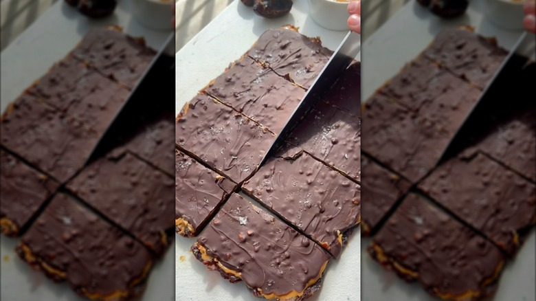 Slicing into slab of chocolate date bark