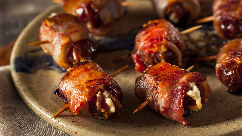 Bacon-wrapped dates on plate