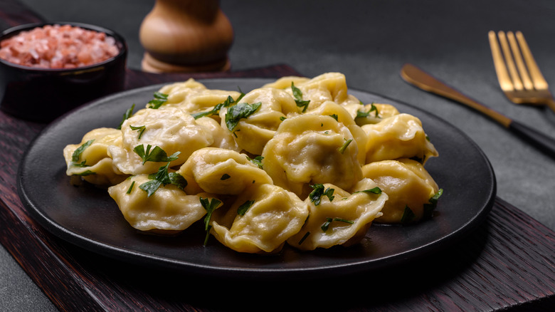 fresh dumplings on black plate 