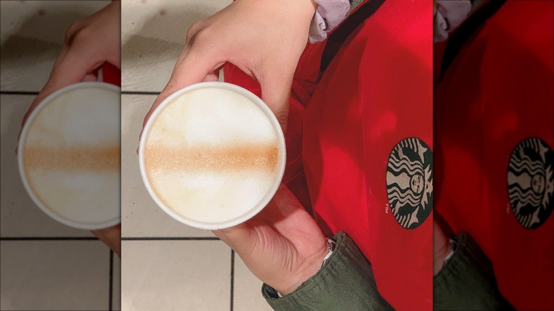 barista holding smoked butterscotch latte