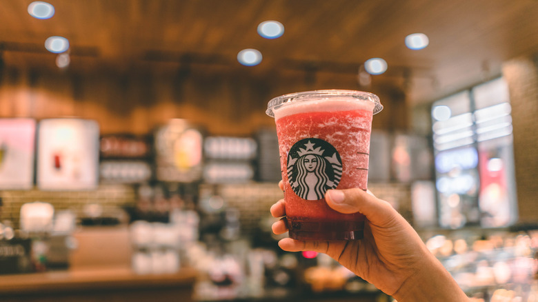 hand holding raspberry syrup drink